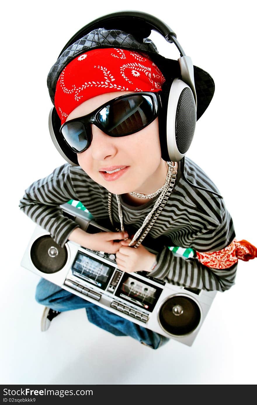 Shot of a trendy teenager listening to music in headphones. Isolated over white background.