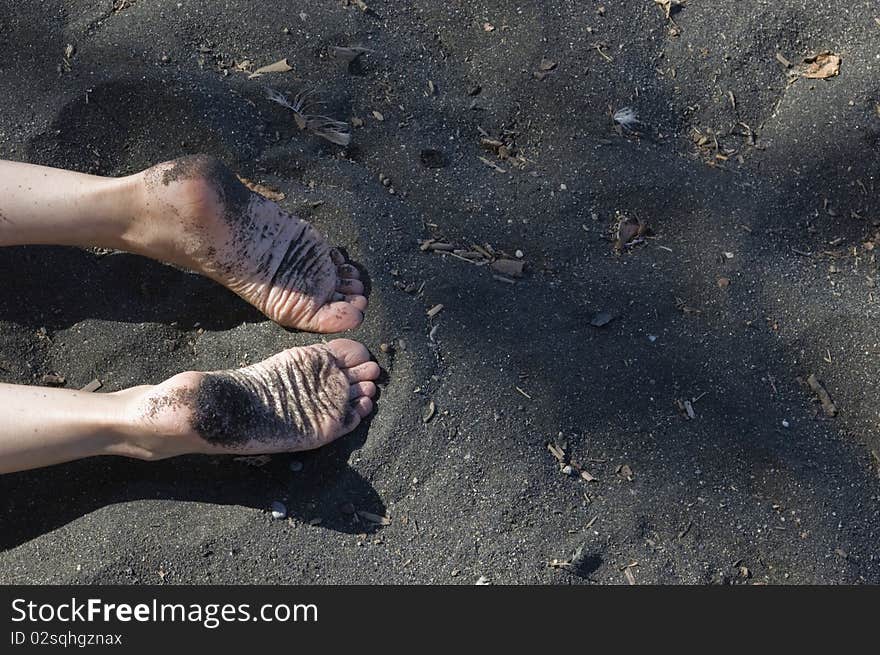 Image of a beach with woman feet