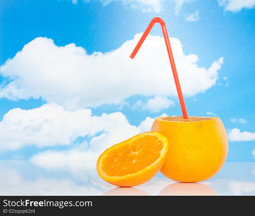 An orange with a straw