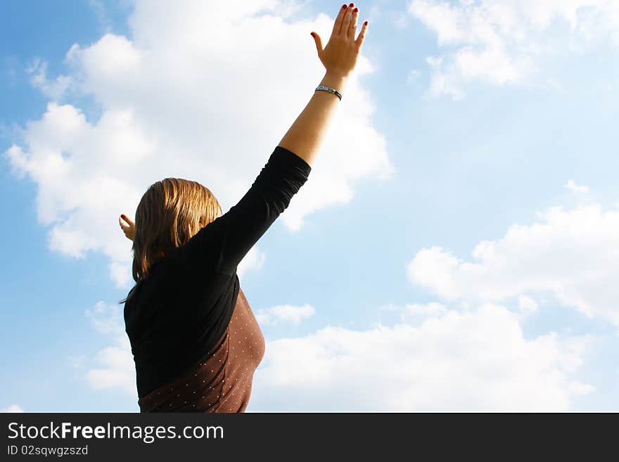 Happy woman on the background of the sky.