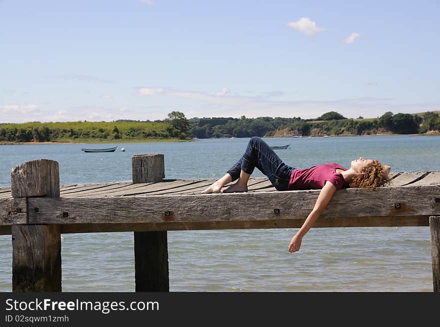 Woman Relaxing On Landing Stage