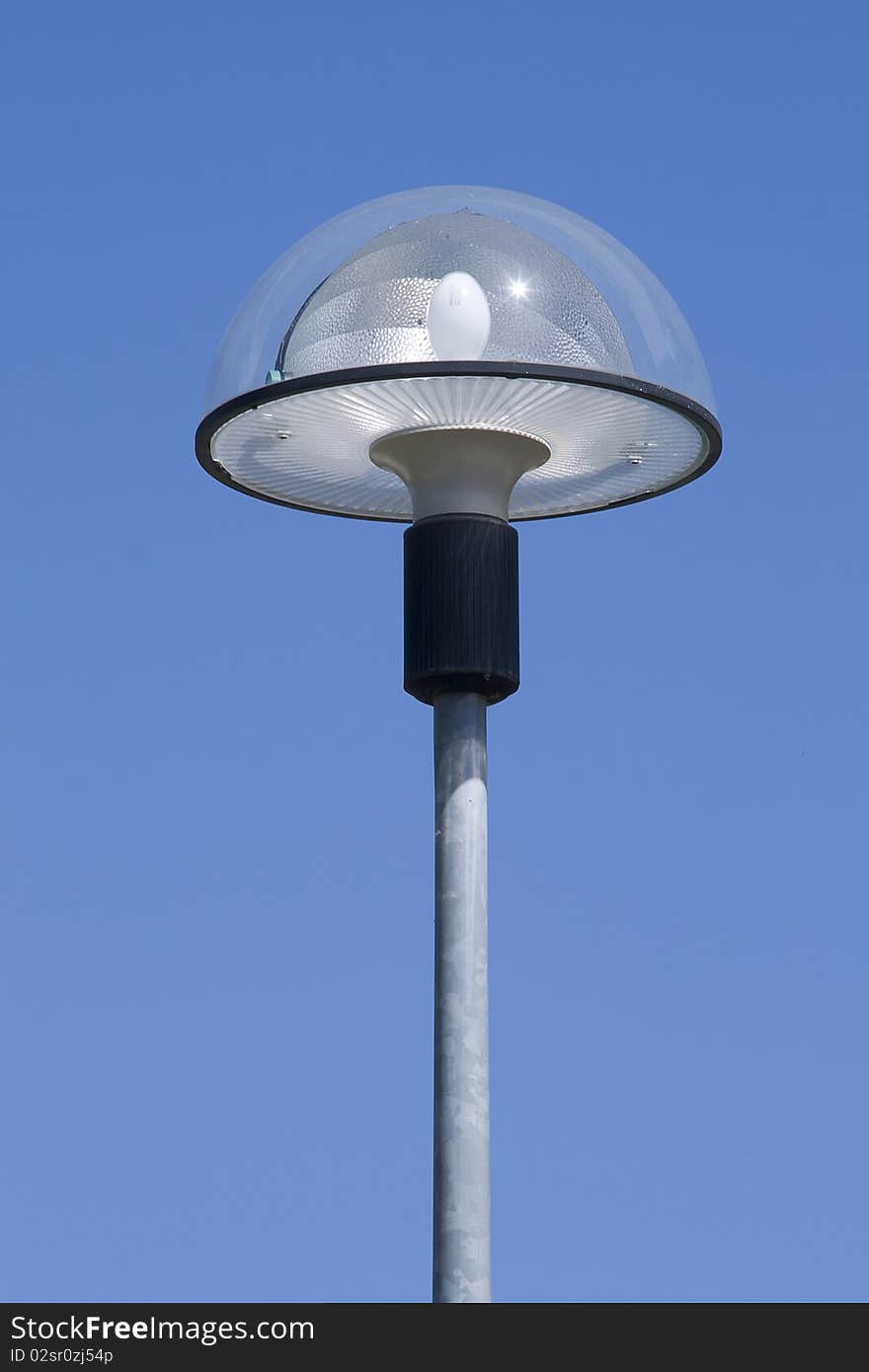 A modern street lamp isolated on a blue sky