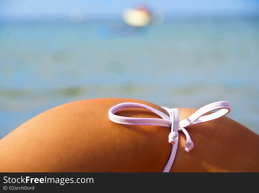 Side of girl on the beach with costumes