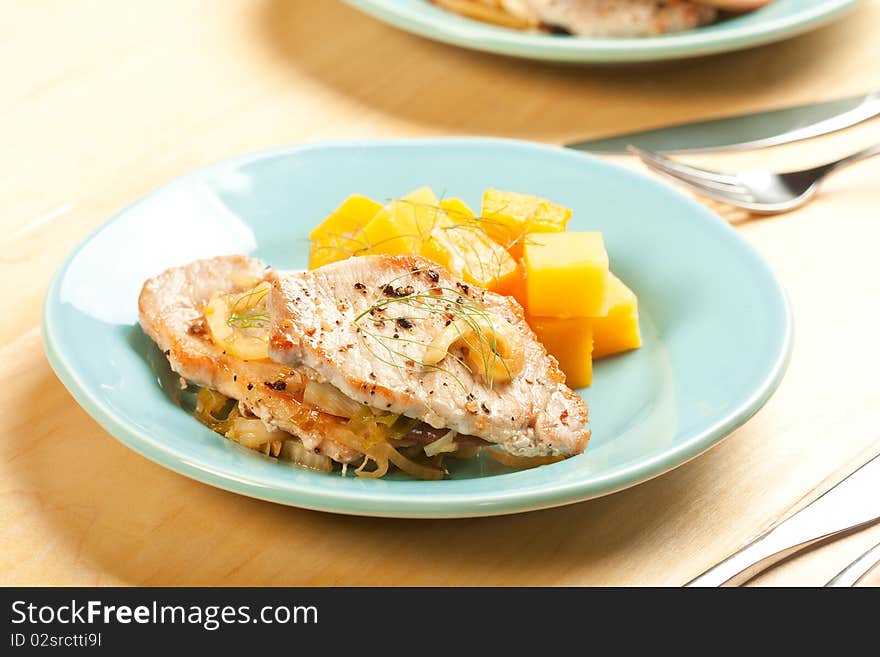 Thin pork chops with apple and fennel accompanied by butternut squash and rutabaga. Thin pork chops with apple and fennel accompanied by butternut squash and rutabaga