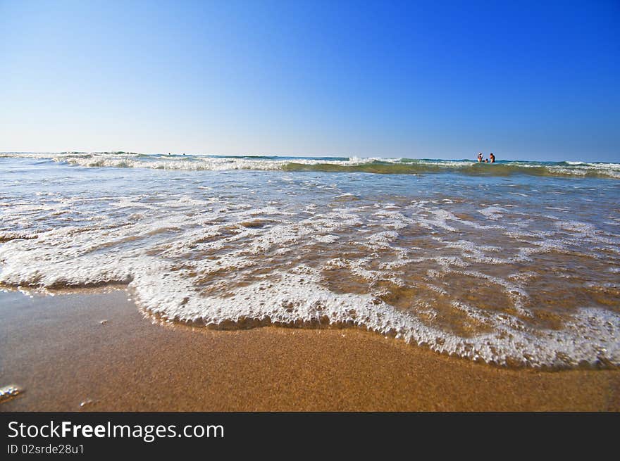 Seashore With Waves And Foam