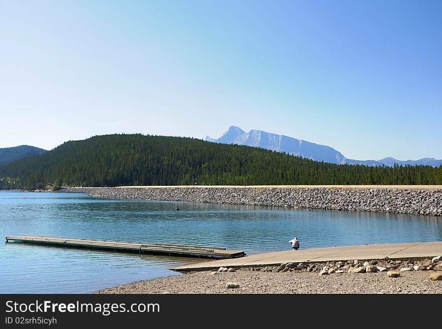 A boy enjoying himself at a lake with mountains in the background. A boy enjoying himself at a lake with mountains in the background