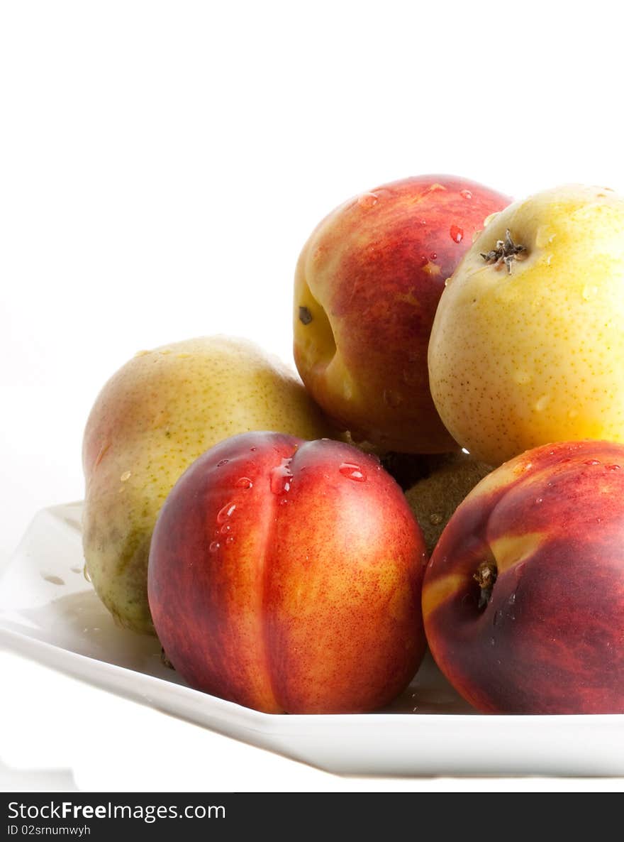 Pears and apricots against a white background. Pears and apricots against a white background