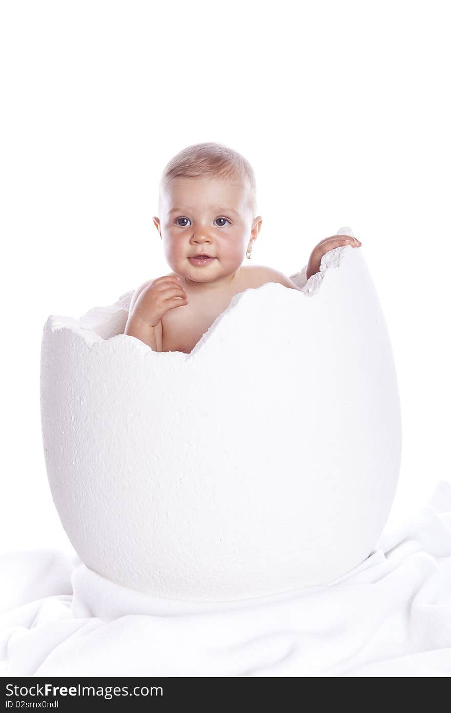 Baby girl in egg on white background