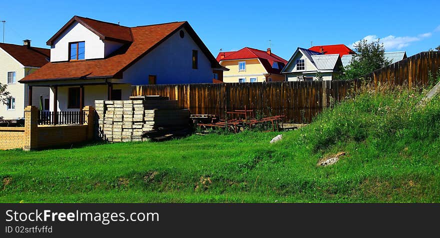 Group of houses, village in summer.