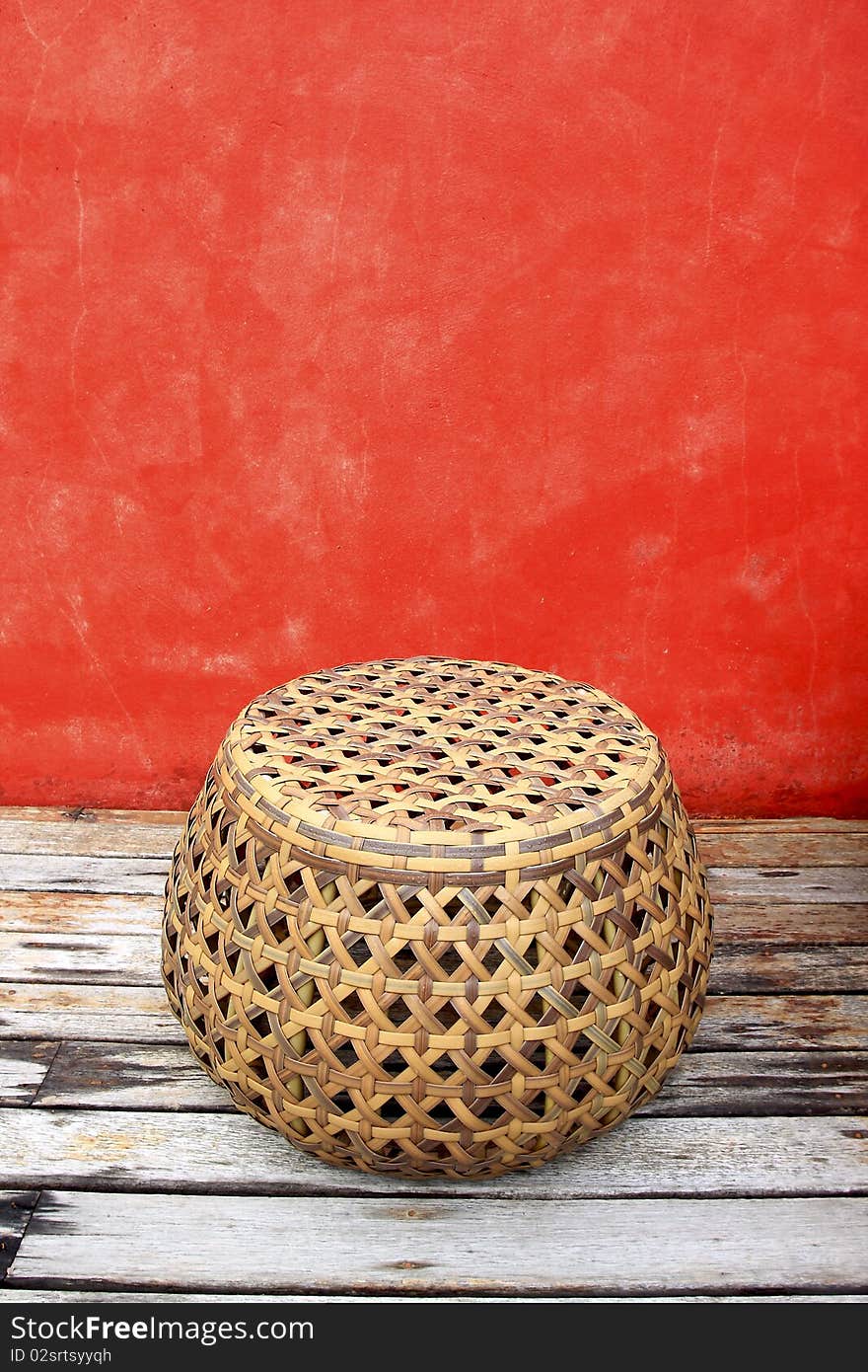 Rattan Chairs With Red Walls On Old Wood