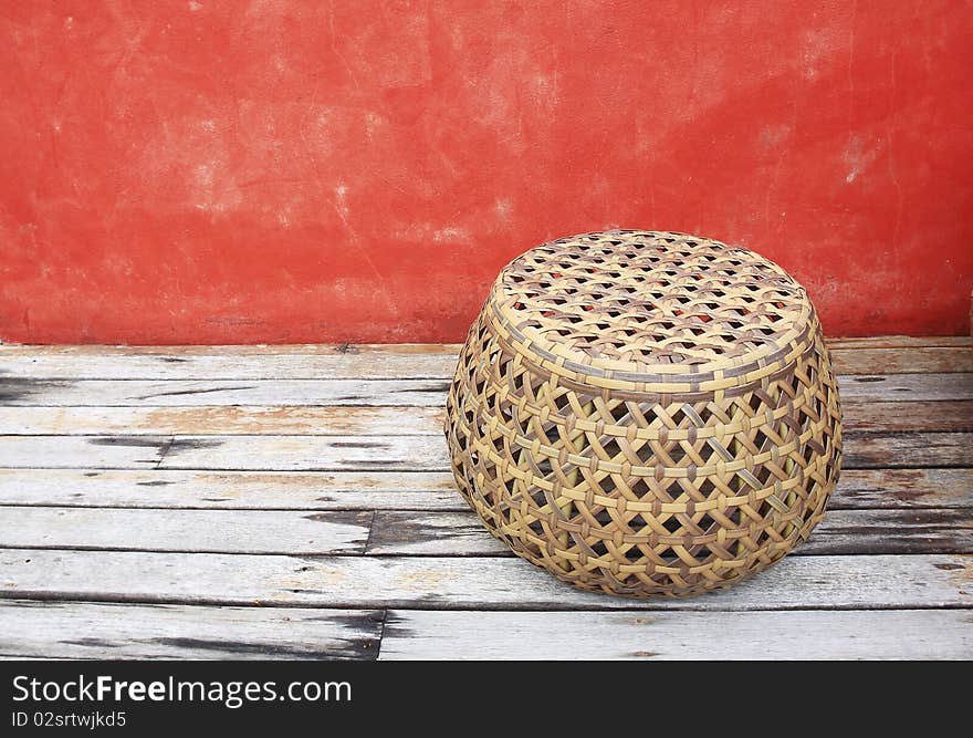 Rattan Chairs With Red Walls On Old Wood