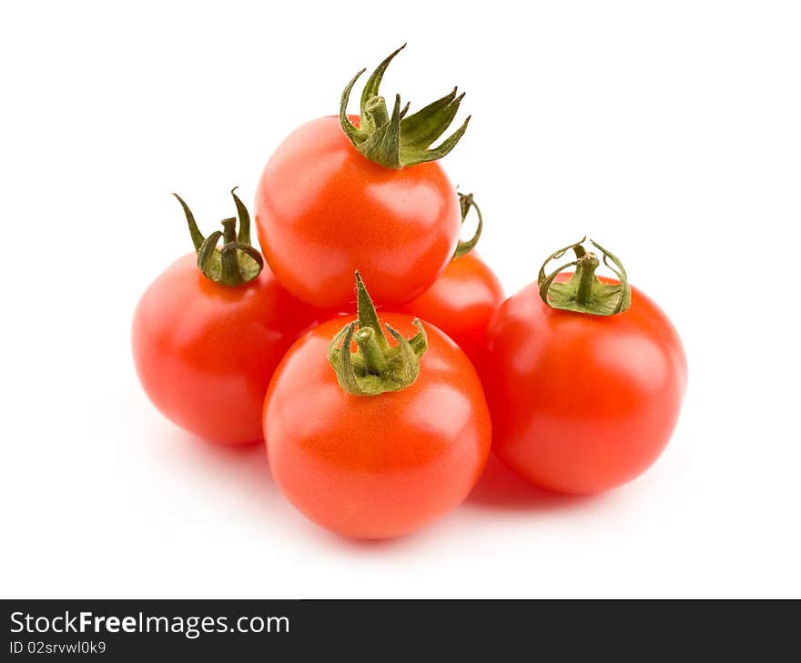 Close up of a pile of cherry tomatoes isolated on white background. Close up of a pile of cherry tomatoes isolated on white background.