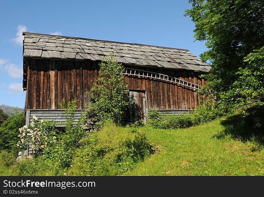 Farm hut amidst orchards and fields above Hardangerfjord, Norway. Farm hut amidst orchards and fields above Hardangerfjord, Norway