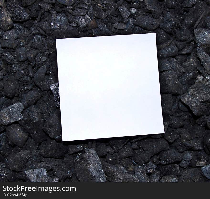 Sheet of paper on coal background