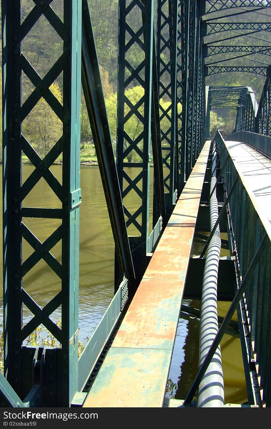 An old steel bridge across the river of Vltava in Davle, Czech Republic