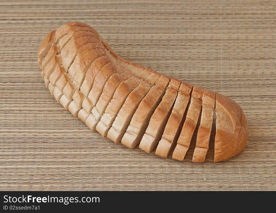 Bread sliced on a bamboo mat