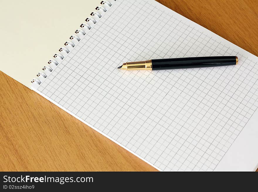 Fountain pen and notebook on the table. Fountain pen and notebook on the table