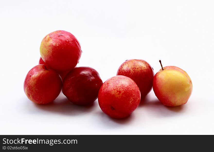 Red plums on white backgrounds.