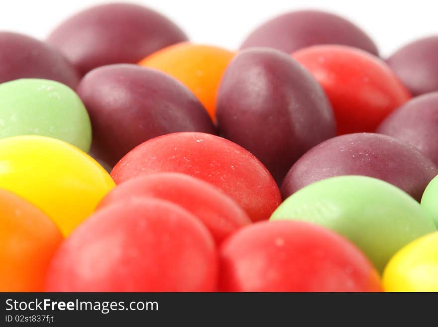 Multicolored candy beans on the white background