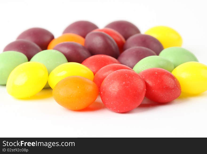 Multicolored candy beans on the white background