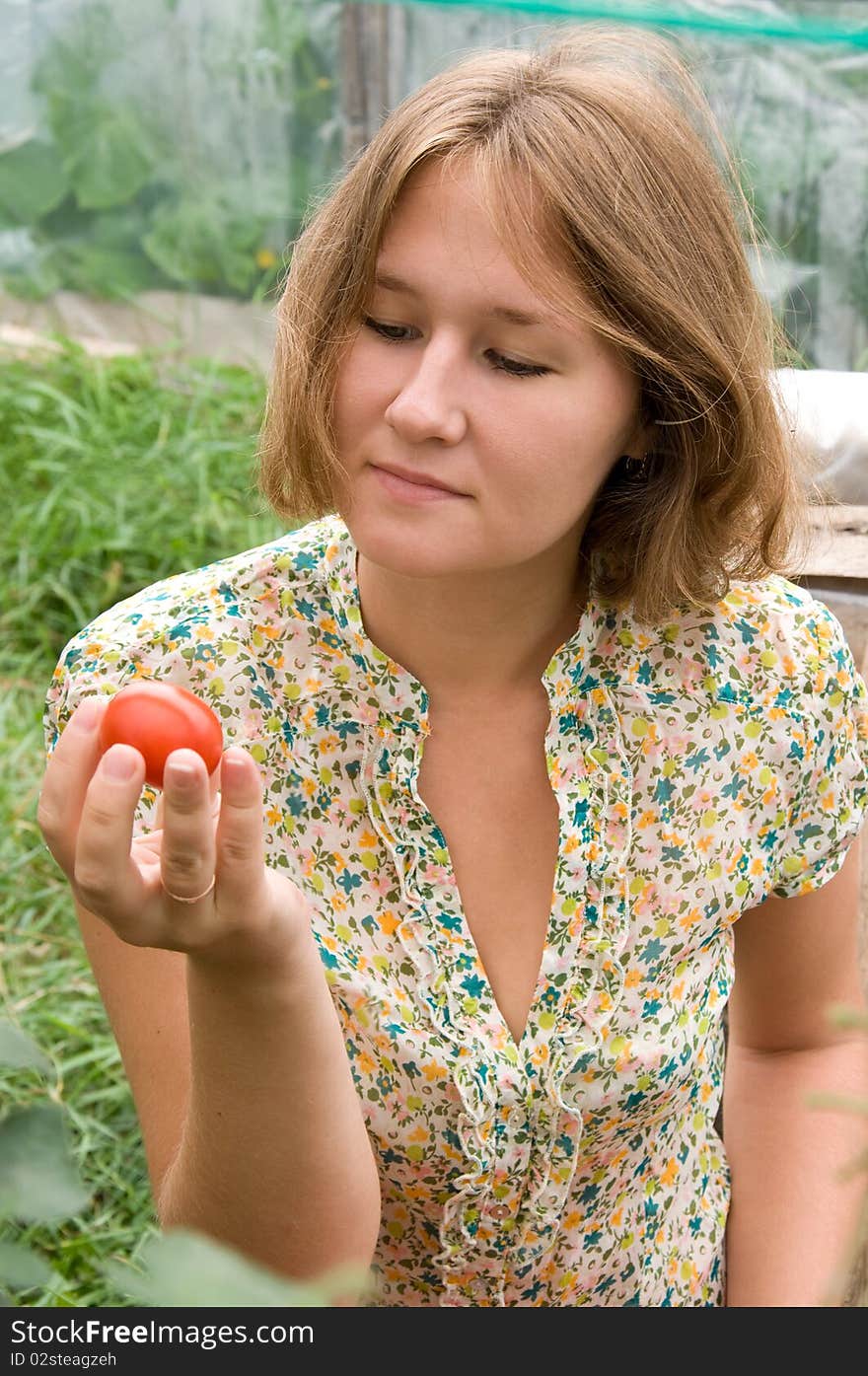 Adorable young farmer is examining harvest