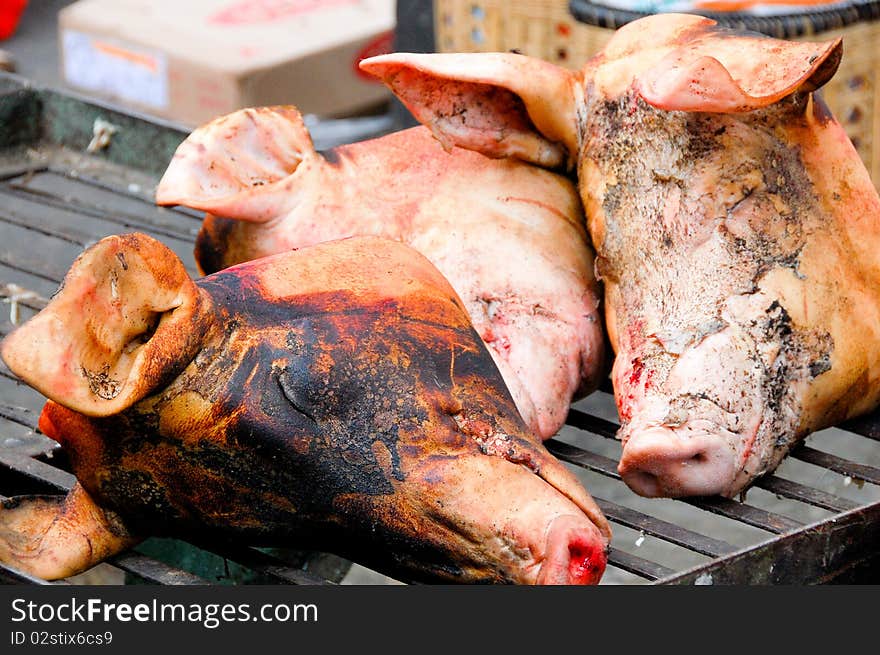 Roasted pork heads at the market in China