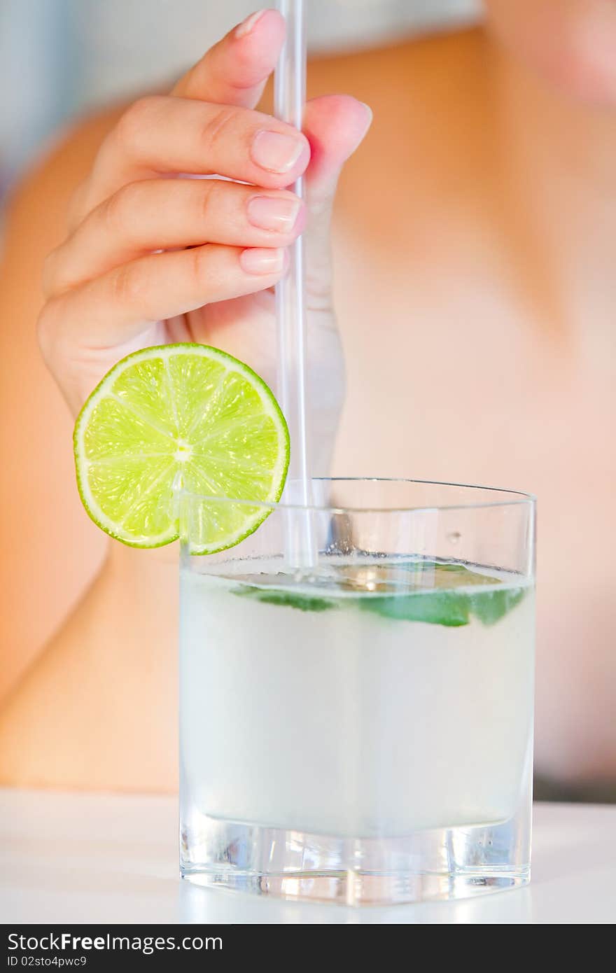 Girl holding straw in lime juice