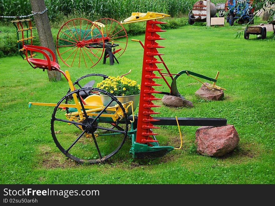 Farm backyard composition with an old agricultural implements