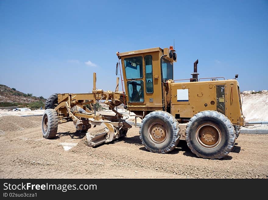 Heavy  tractor working on a new road. Heavy  tractor working on a new road