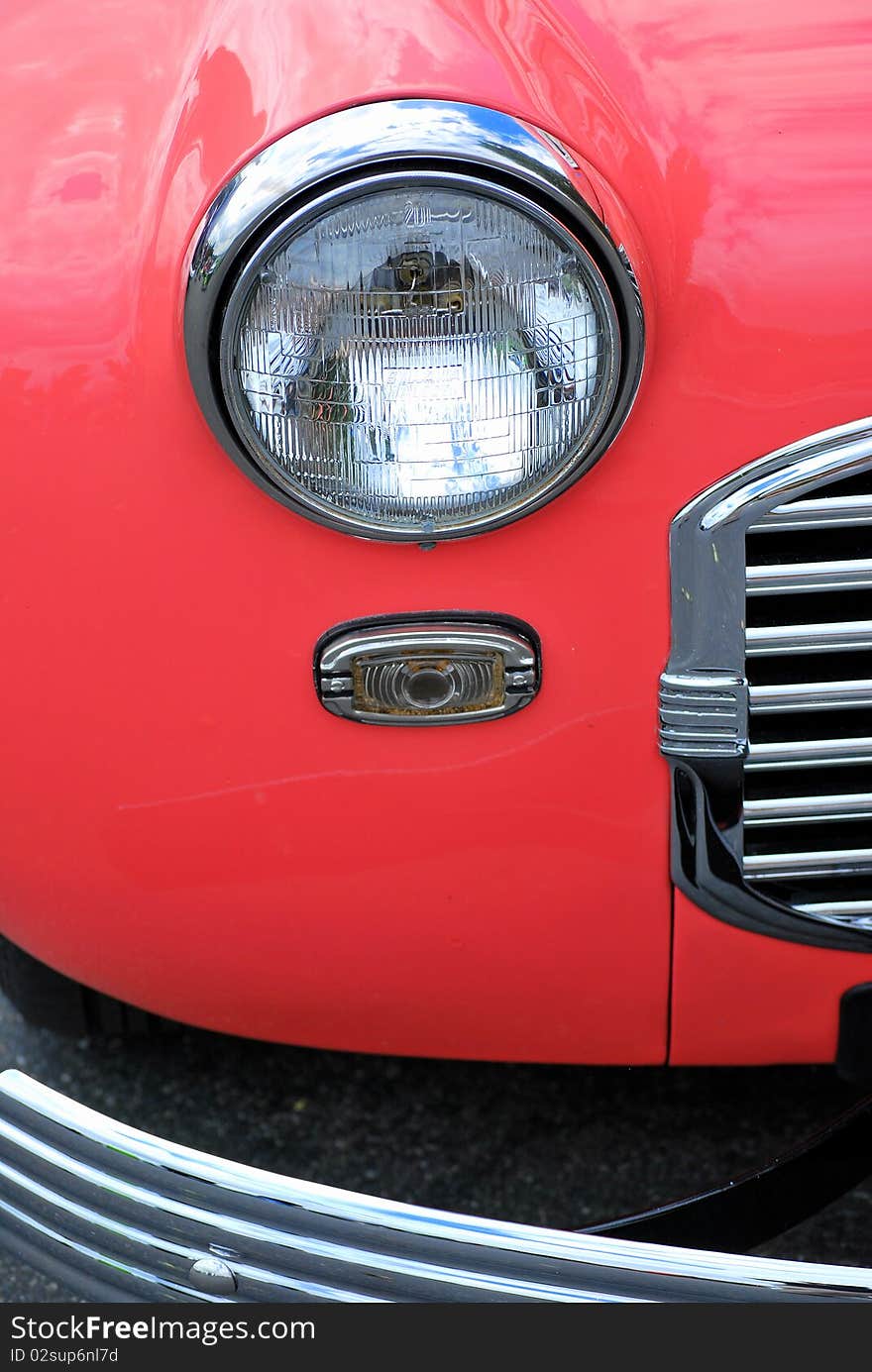 Closeup of a classic vintage car displayed outdoors.