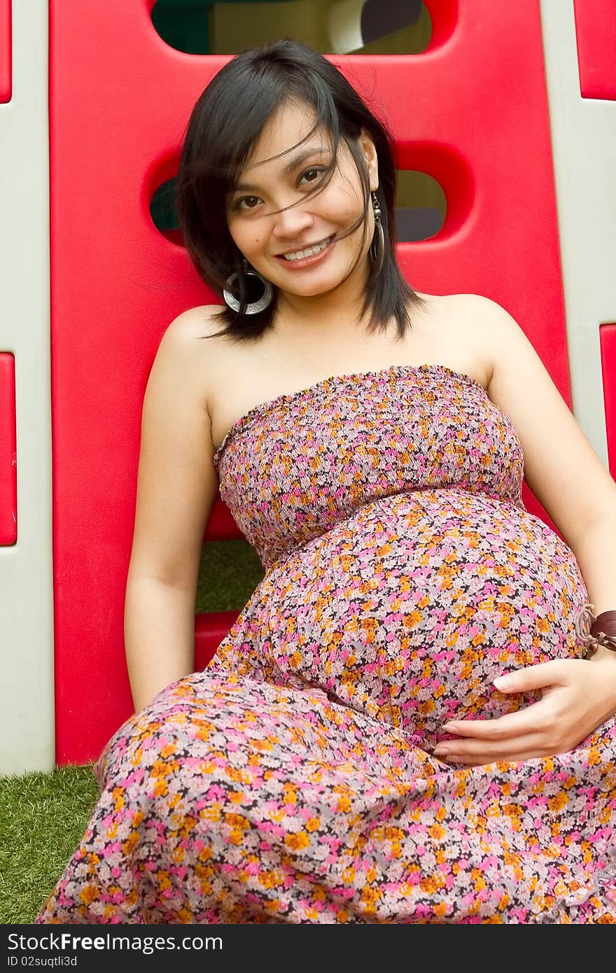 Portrait of healthy Asian ethnic pregnant woman at playground. Portrait of healthy Asian ethnic pregnant woman at playground