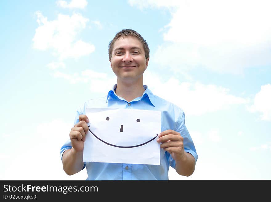 A young man holds a sheet of paper