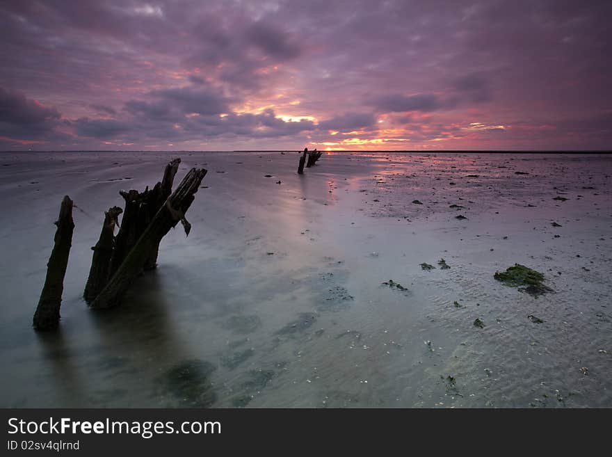 Romantic and dramatic red sunrise over the Wadden sea in the Netherlands. Romantic and dramatic red sunrise over the Wadden sea in the Netherlands