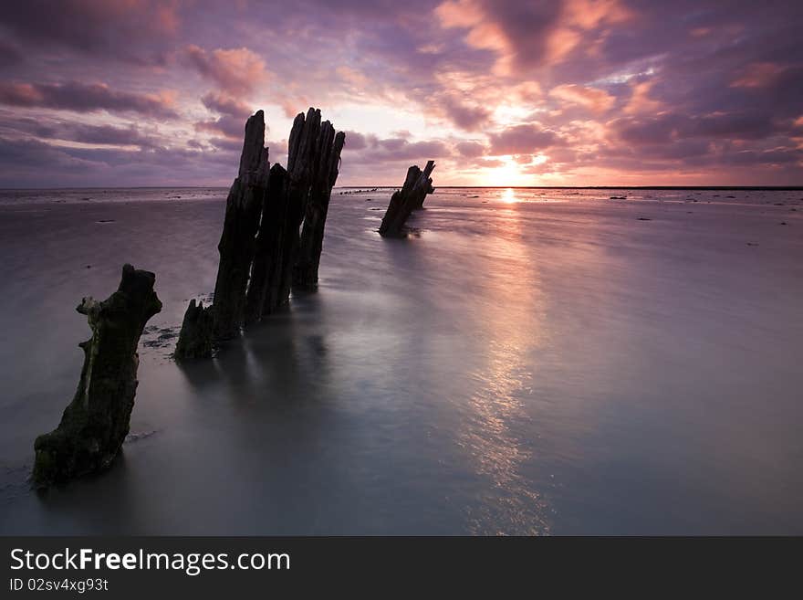 Romantic and dramatic red sunrise over the Wadden sea in the Netherlands. Romantic and dramatic red sunrise over the Wadden sea in the Netherlands