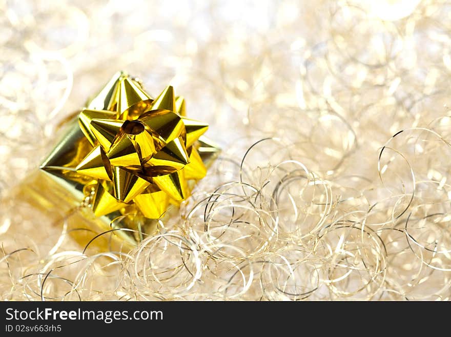 Golden gift in front of golden background. Golden gift in front of golden background