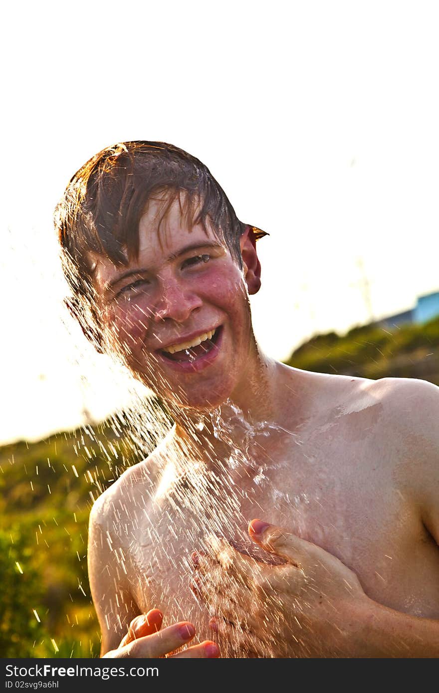 Boy has a shower at the beach