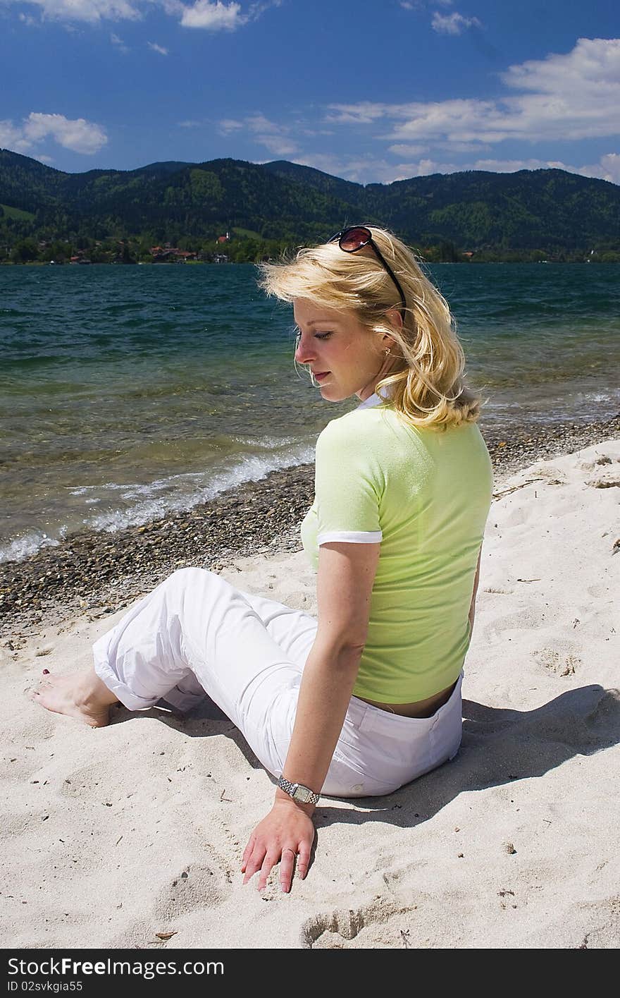 Young blonde woman vacationing at the beach. Young blonde woman vacationing at the beach