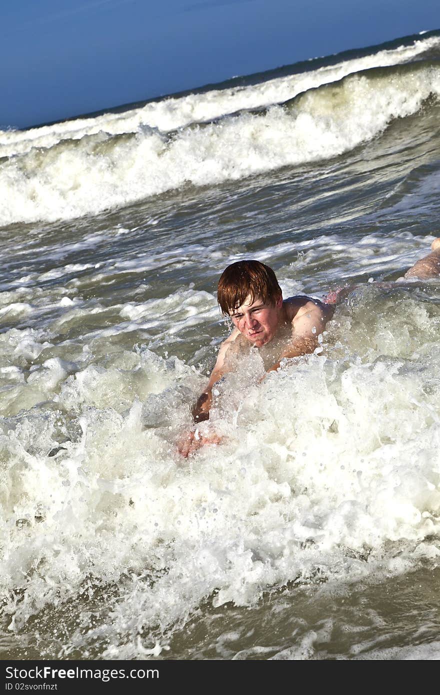 Child has fun in the waves of the ocean