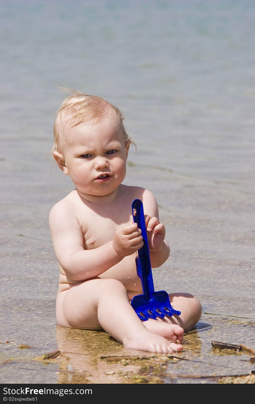 Potrait of  baby boy sitting in sea water. Potrait of  baby boy sitting in sea water