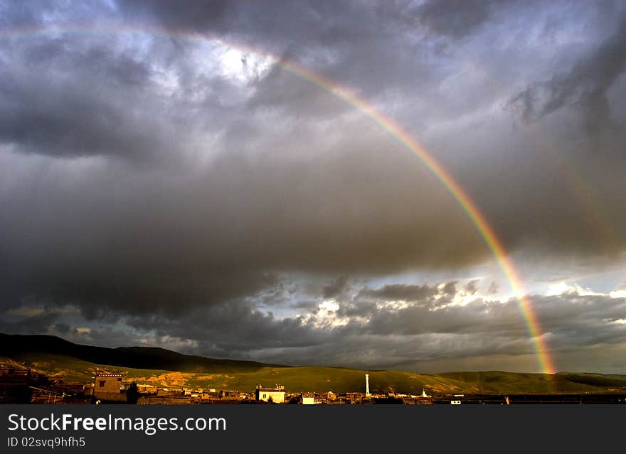 Rainbow in heavy cloud after rain.