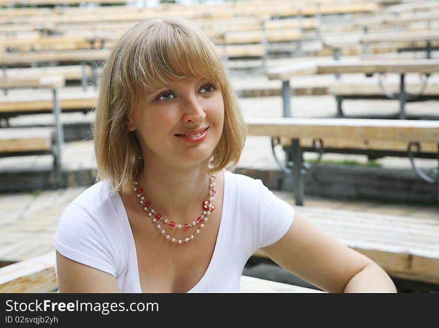 The smiling young woman in park. The smiling young woman in park