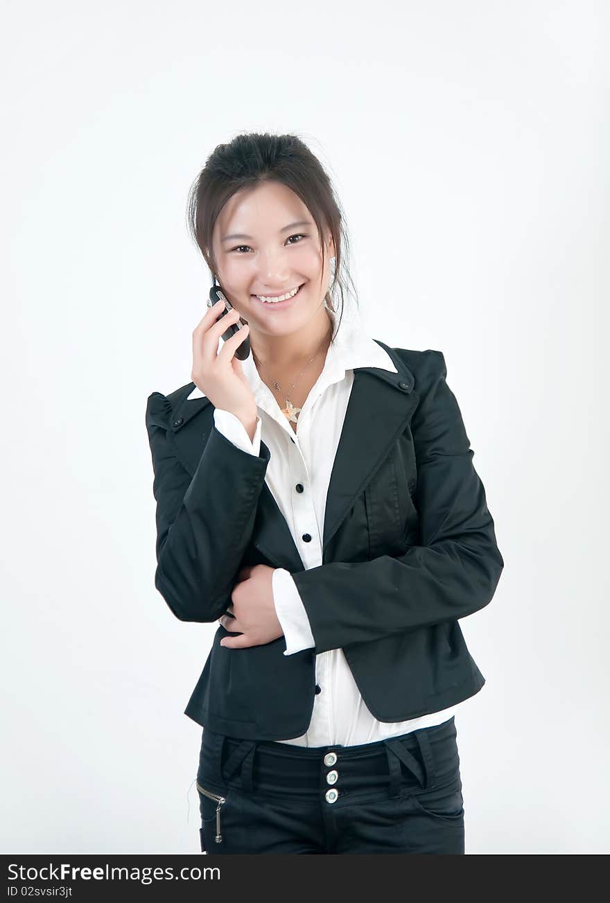 A Beautiful Asian business woman is on her cell phone. A Beautiful Asian business woman is on her cell phone