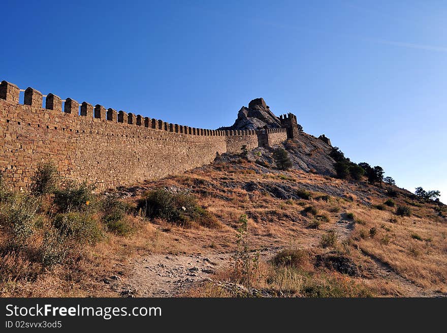 Age-old beautiful fortress wall with the loop-holes of the Genoese fortress in the Crimean mountains of Ukraine