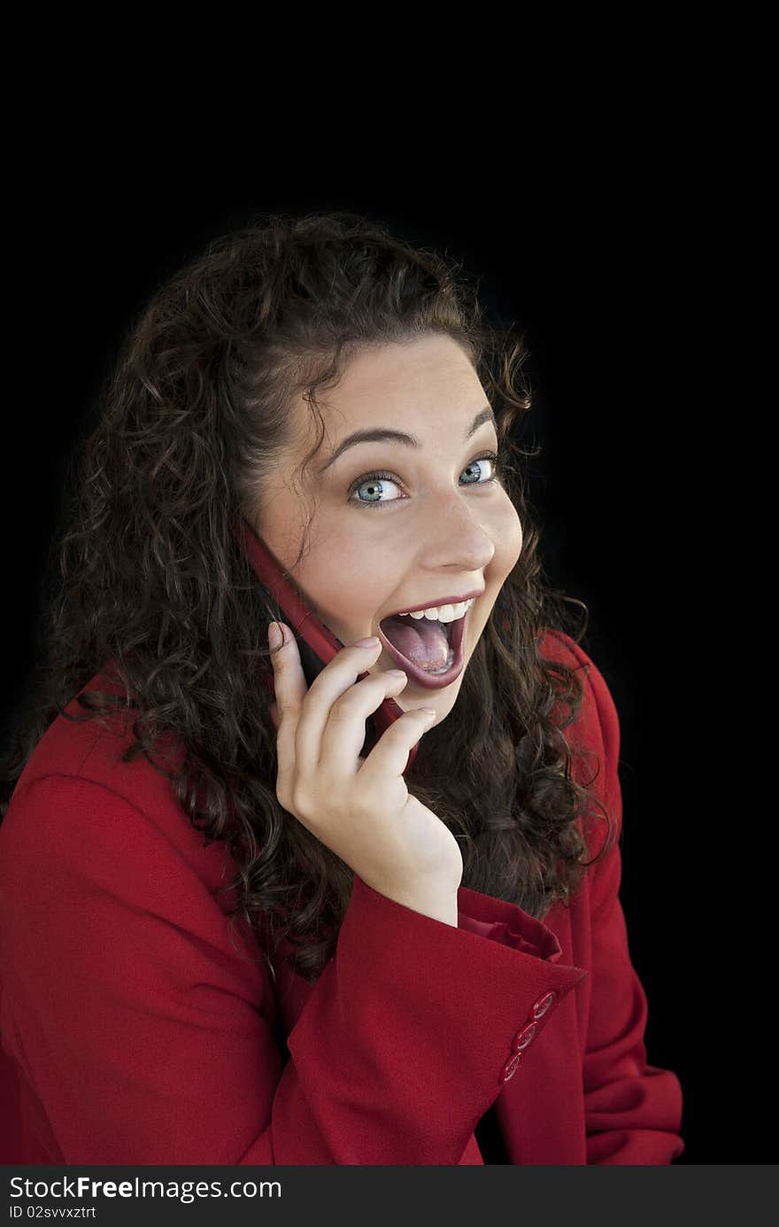 A beautiful young business woman on phone with a surprised expression on her face. A beautiful young business woman on phone with a surprised expression on her face