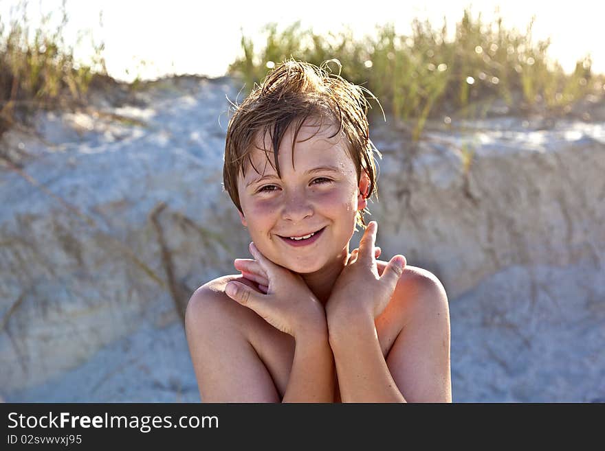 Young happy smiling boy at the beach