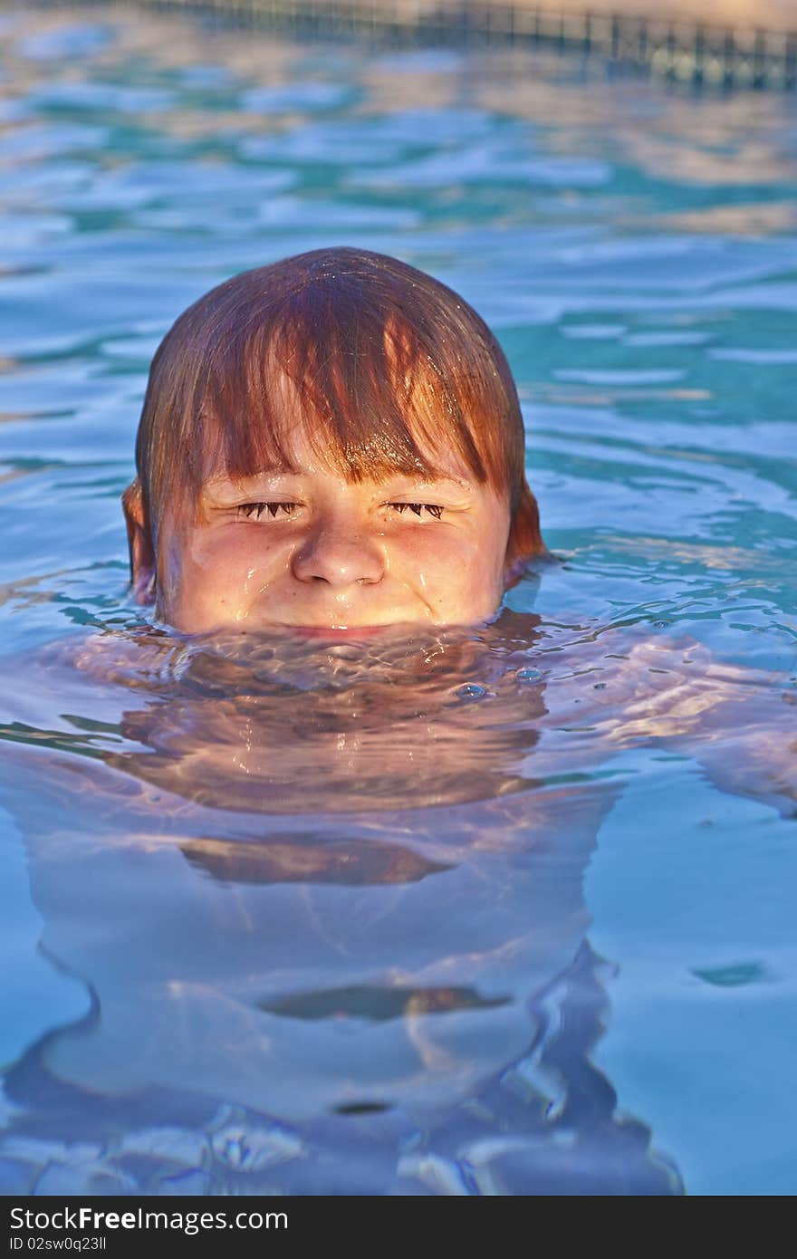 Young child has fun in the outdoor pool