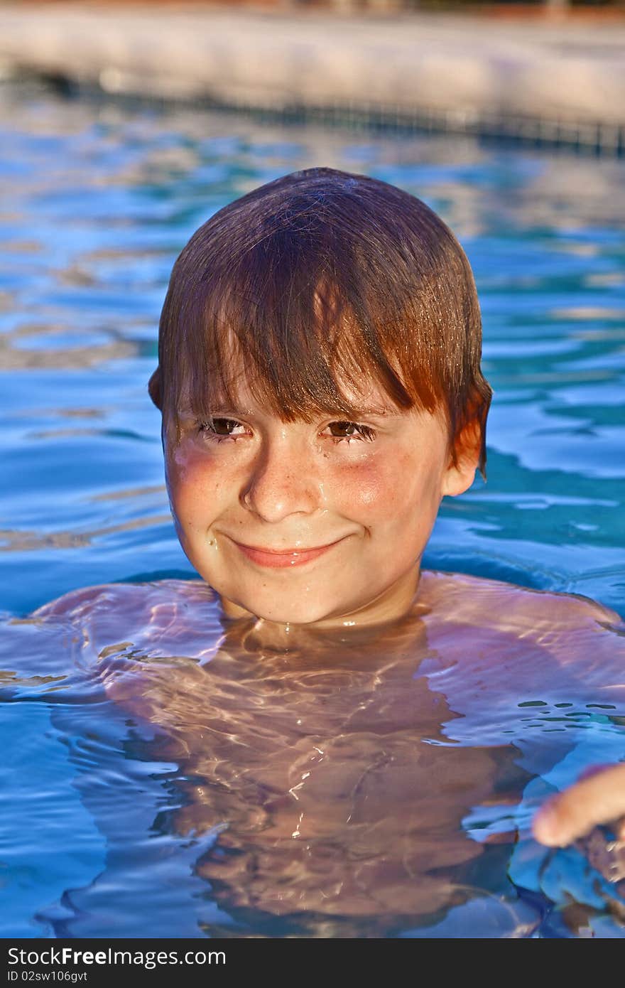 Smiling child has fun in the outdoor pool