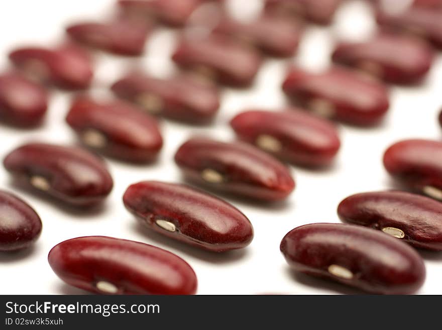 Seeds of red beans are in regular rows. Taken across the series. Isolated on white background. Seeds of red beans are in regular rows. Taken across the series. Isolated on white background.