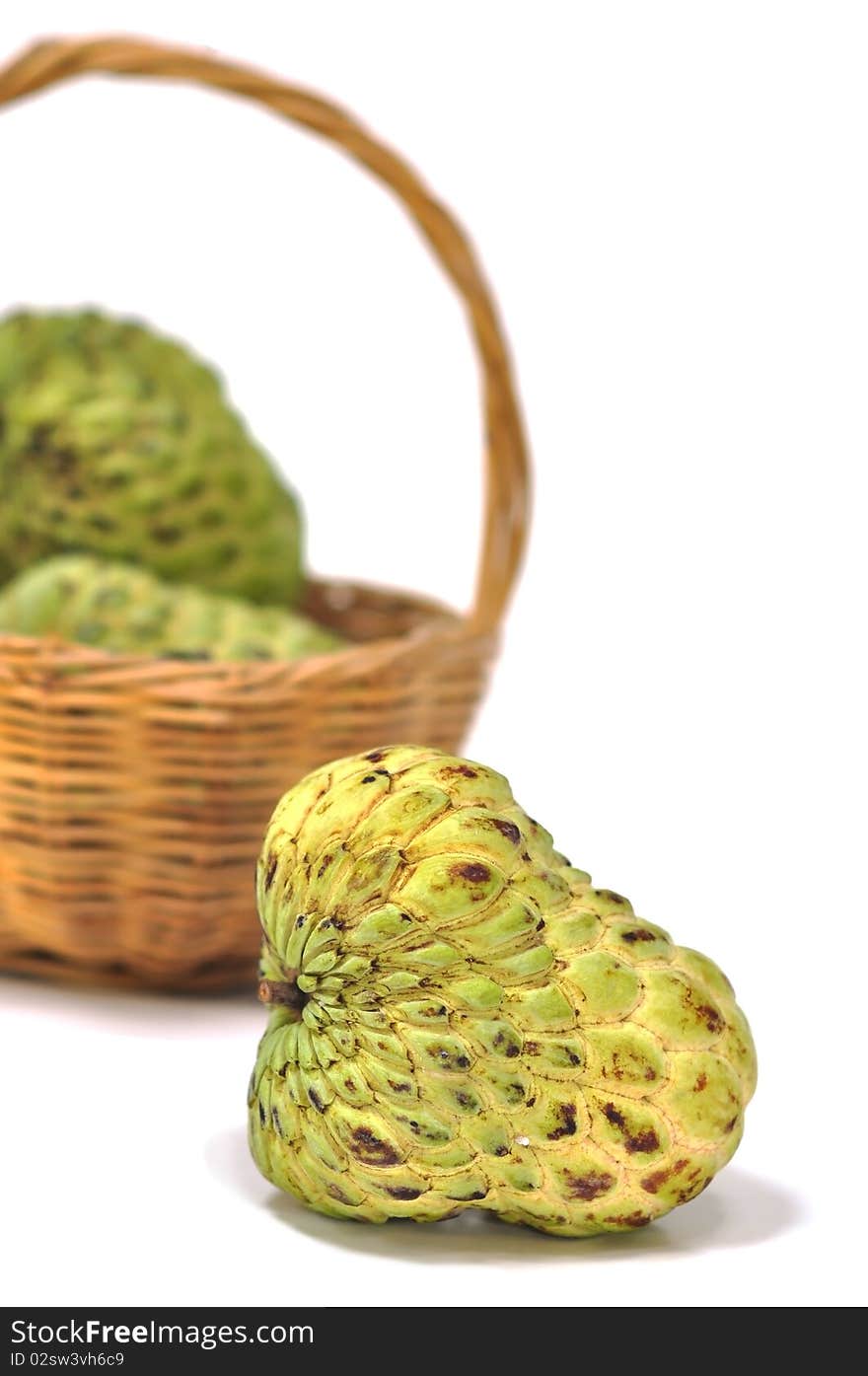 A basket of custard apple in the white background