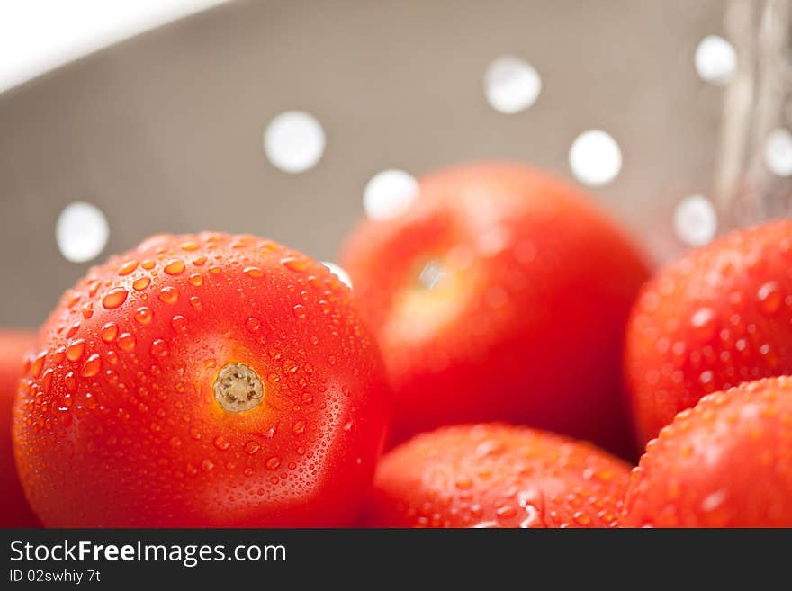 Fresh, Vibrant Roma Tomatoes in Colander with Wate